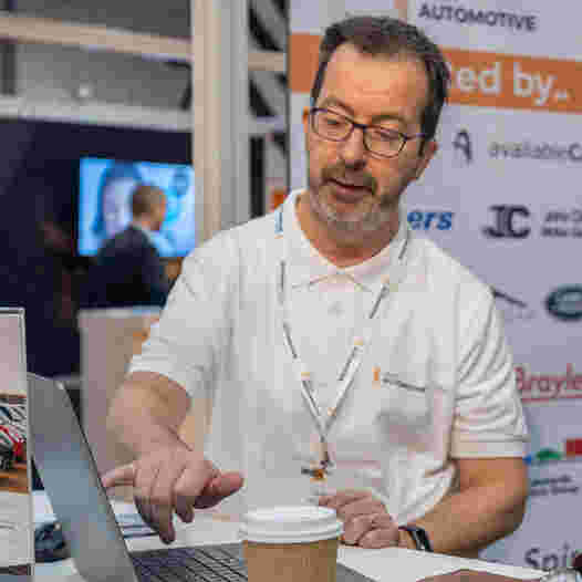 CEO John Hogan looking at laptop